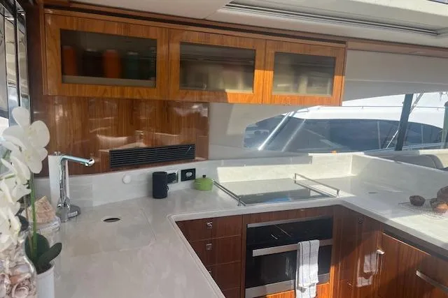  Yacht Photos Pics Luxurious kitchen interior of 2020 Riviera 6000 Sport Yacht Platinum Edition.