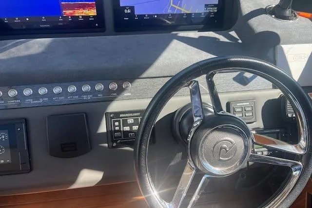  Yacht Photos Pics 2020 Riviera 6000 Sport Yacht Platinum Edition dashboard with steering wheel and navigation screens.