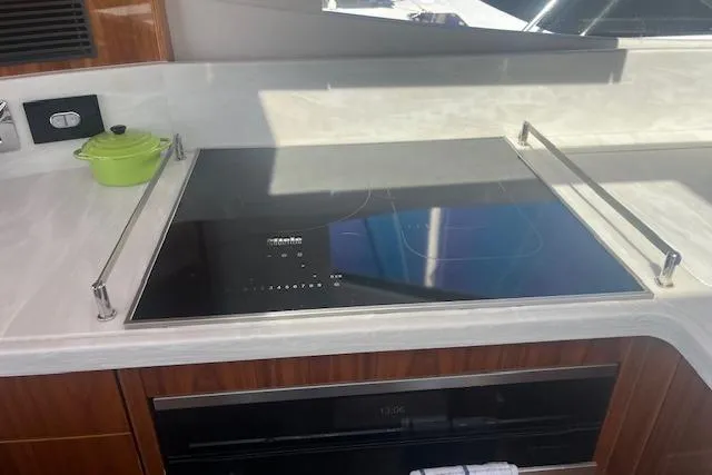  Yacht Photos Pics Modern kitchen in 2020 Riviera 6000 Sport Yacht Platinum Edition with induction cooktop.