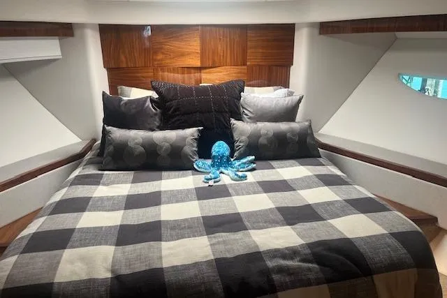  Yacht Photos Pics Luxurious bedroom in 2020 Riviera 6000 Sport Yacht Platinum Edition with plush bedding and decor.