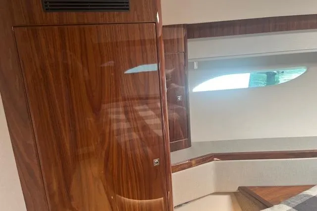  Yacht Photos Pics Interior of 2020 Riviera 6000 Sport Yacht Platinum Edition with polished wood finish.