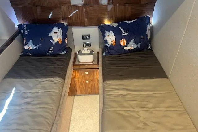  Yacht Photos Pics Twin beds with shark-themed pillows in 2020 Riviera 6000 Sport Yacht cabin.