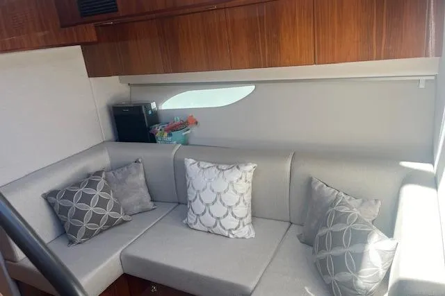  Yacht Photos Pics 2020 Riviera 6000 Sport Yacht Platinum Edition interior with elegant seating and decorative pillows.