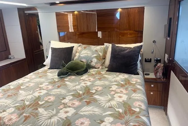  Yacht Photos Pics Luxurious bedroom interior of 2020 Riviera 6000 Sport Yacht Platinum Edition with floral bedding.