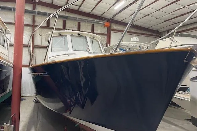 Picnic Boat Yacht Photos Pics 2003 Legacy Yachts 34 Express in storage, showcasing sleek design and craftsmanship.