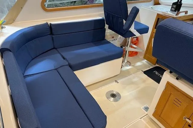 Picnic Boat Yacht Photos Pics Interior of 2003 Legacy Yachts 34 Express with blue seating and wooden accents.