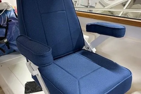 Picnic Boat Yacht Photos Pics Blue captain's chair on 2003 Legacy Yachts 34 Express boat, featuring armrests and cushioned seating.