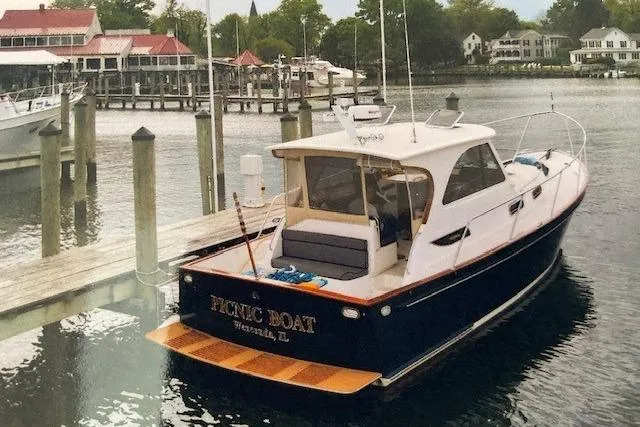 Picnic Boat Yacht Photos Pics 2003 Legacy Yachts 34 Express docked at a marina with scenic waterfront views.