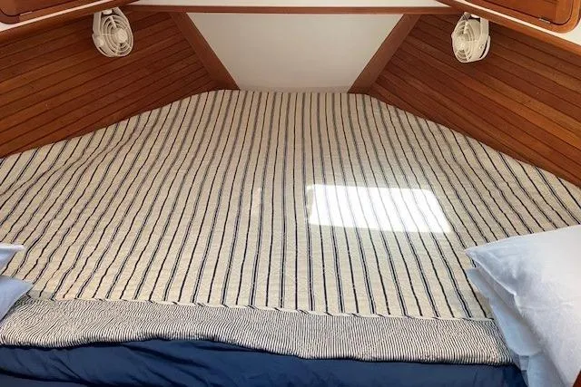 Picnic Boat Yacht Photos Pics Cozy cabin interior of 2003 Legacy Yachts 34 Express with striped bedding.