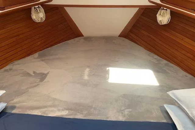 Picnic Boat Yacht Photos Pics Cozy interior cabin of 2003 Legacy Yachts 34 Express with wooden paneling and soft lighting.