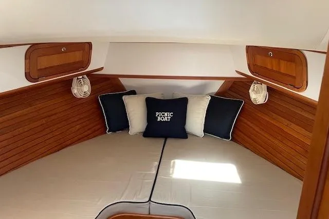 Picnic Boat Yacht Photos Pics 2003 Legacy Yachts 34 Express cabin with cozy bedding and wooden accents.