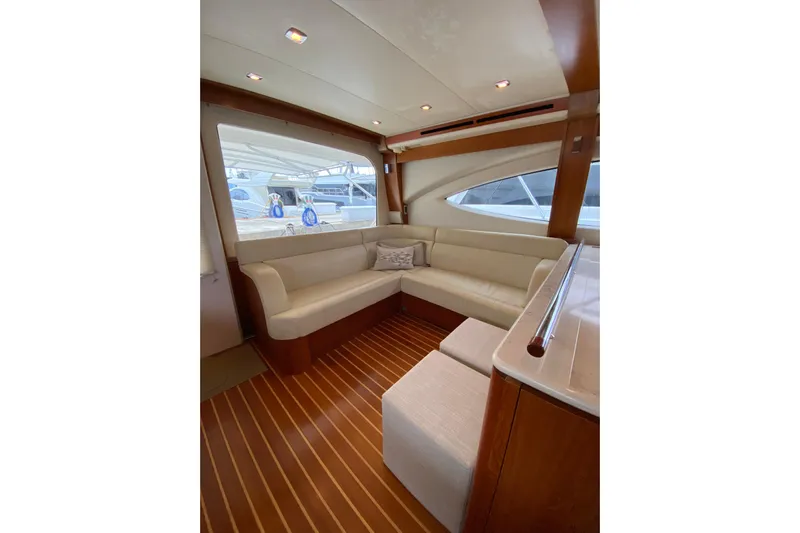 Cometa Yacht Photos Pics Luxurious interior of 2012 Tiara Yachts 4800 Convertible with elegant seating and wood flooring.