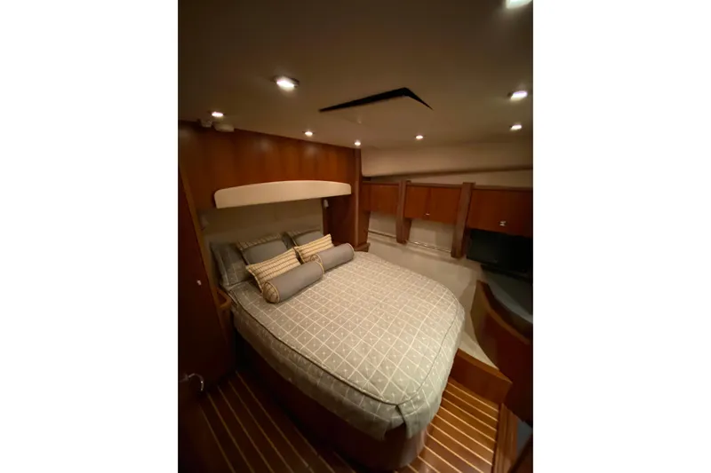 Cometa Yacht Photos Pics Luxurious bedroom interior of 2012 Tiara Yachts 4800 Convertible with elegant bedding and wood finish.