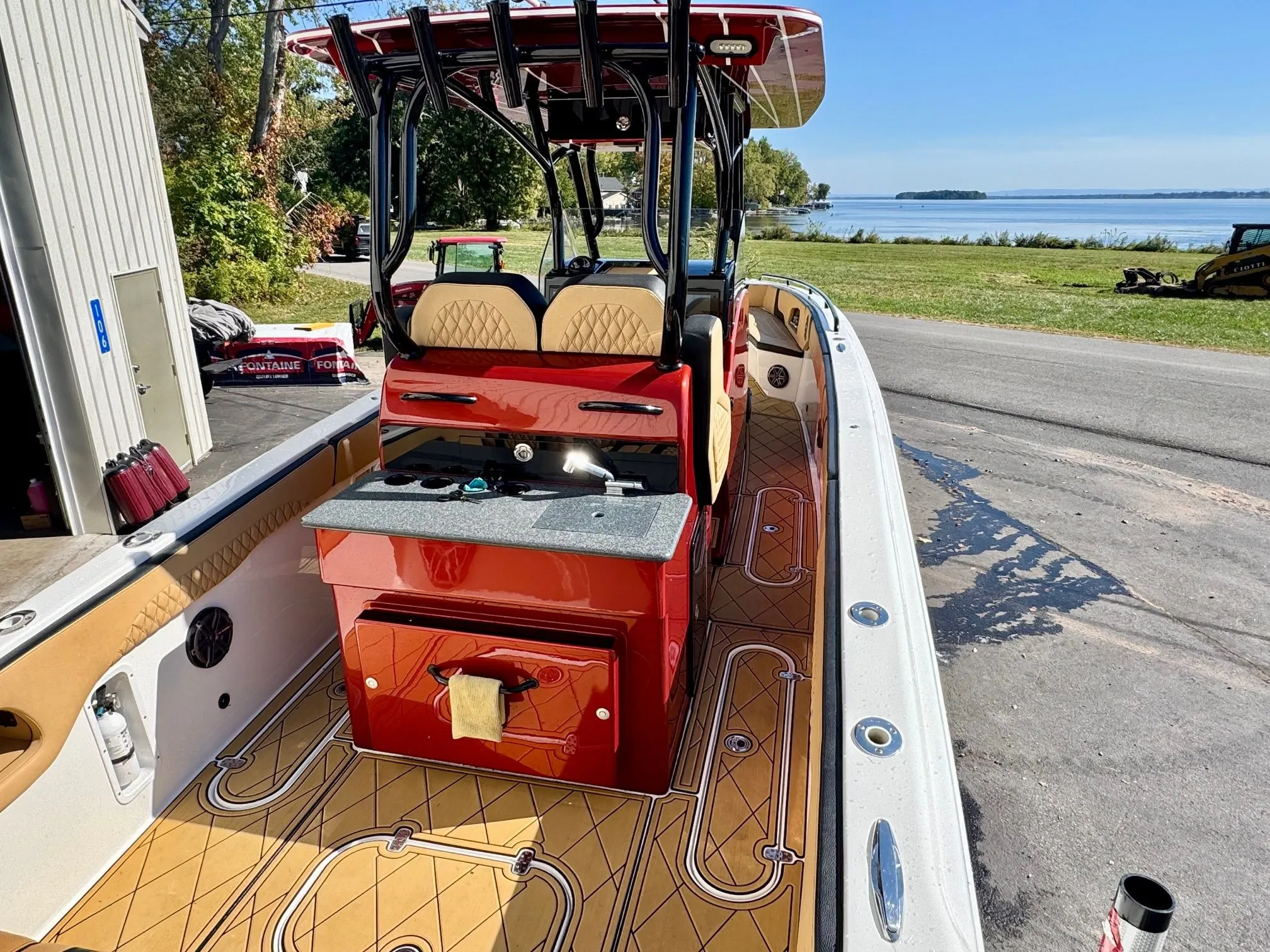 2019 Concept 36' Open Deck boat parked by the shore.