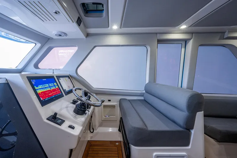 Mother Mary Yacht Photos Pics Interior helm station of 2021 Gulf Crosser 52 yacht with navigation screens and seating.
