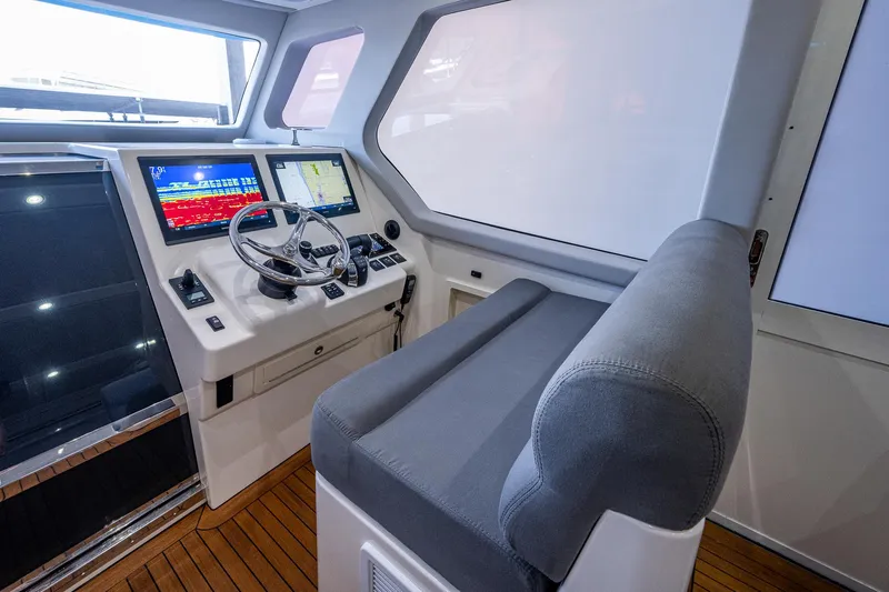 Mother Mary Yacht Photos Pics 2021 Gulf Crosser 52 helm station with modern navigation displays and comfortable seating.