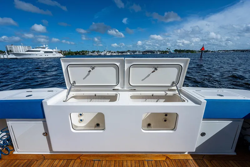 Mother Mary Yacht Photos Pics 2021 Gulf Crosser 52 boat with open storage compartments on deck, docked by the water.