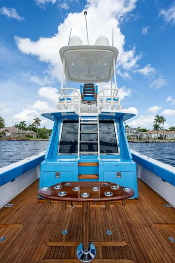 Mother Mary Yacht Photos Pics 2021 Gulf Crosser 52 yacht with blue accents and wooden deck on the water.