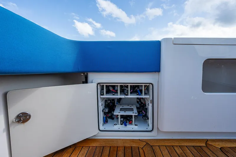 Mother Mary Yacht Photos Pics Gulf Crosser 52 (2021) yacht with open storage compartment and blue cushioned seating.