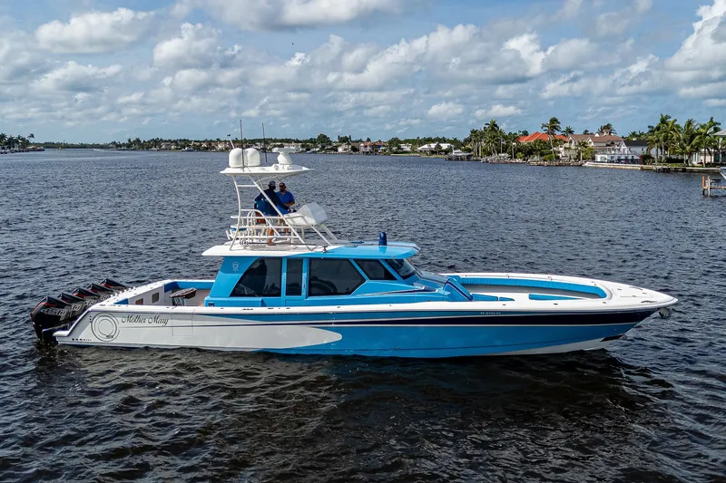 Mother Mary Yacht Photos Pics 2021 Gulf Crosser 52 boat cruising on a calm waterway under a partly cloudy sky.