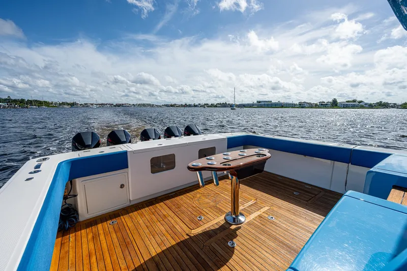 Mother Mary Yacht Photos Pics 2021 Gulf Crosser 52 boat deck with wooden flooring and ocean view.