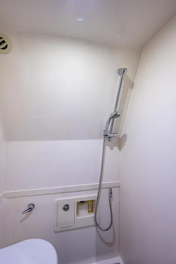 Mother Mary Yacht Photos Pics 2021 Gulf Crosser 52 yacht bathroom with showerhead and white interior.