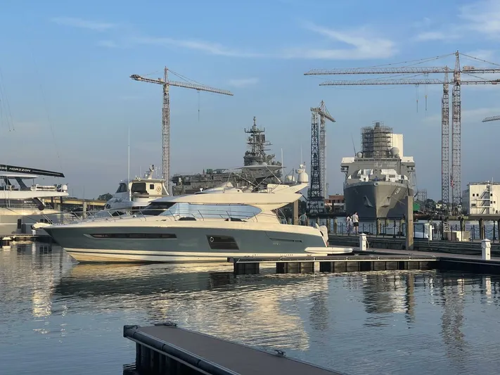 Blue Haven Yacht Photos Pics Prestige 620S yacht docked in marina with cranes and ships in background, 2014 model.
