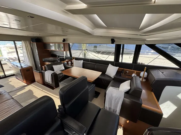 Blue Haven Yacht Photos Pics Luxurious interior of a 2014 Prestige 620S yacht with elegant seating and panoramic windows.