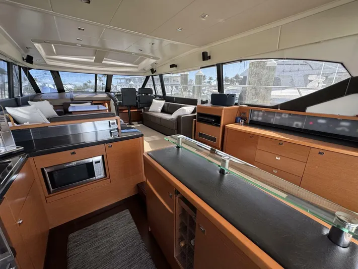 Blue Haven Yacht Photos Pics Luxurious interior of a 2014 Prestige 620S yacht with modern kitchen and seating area.