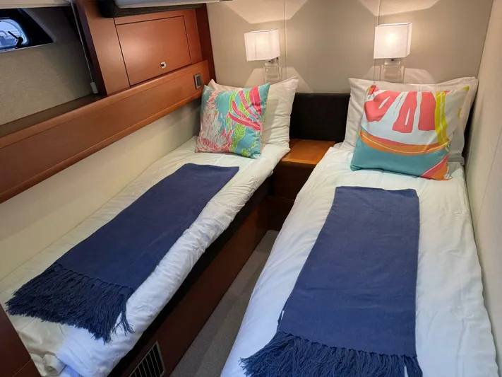 Blue Haven Yacht Photos Pics Twin cabin interior of 2014 Prestige 620S yacht with colorful pillows and blue throws.