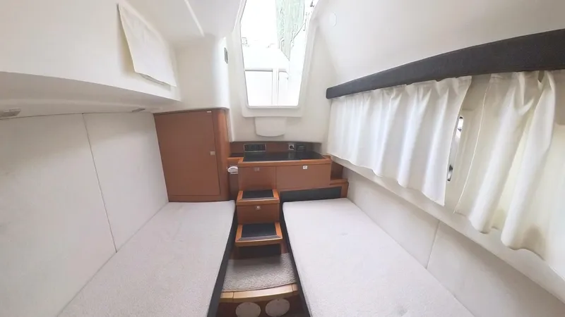 Blue Haven Yacht Photos Pics Interior cabin of 2014 Prestige 620S yacht with twin beds and wooden accents.