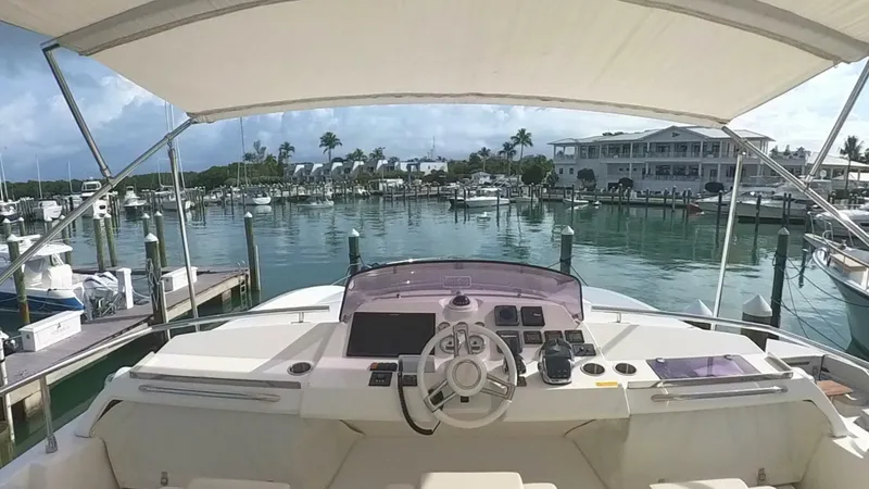 Blue Haven Yacht Photos Pics Prestige 620S 2014 yacht helm with marina view, sunny day, calm waters.