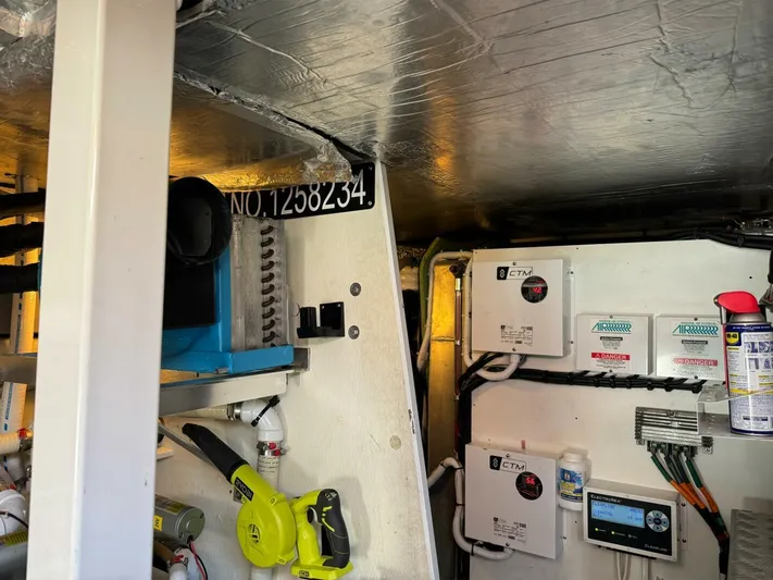 Blue Haven Yacht Photos Pics Engine room of a 2014 Prestige 620S yacht with equipment and tools.