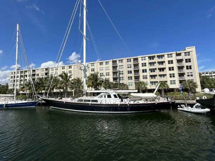 Toto Yacht Photos Pics Palmer Johnson 110 Cruising Sloop 1983 docked near waterfront apartments.