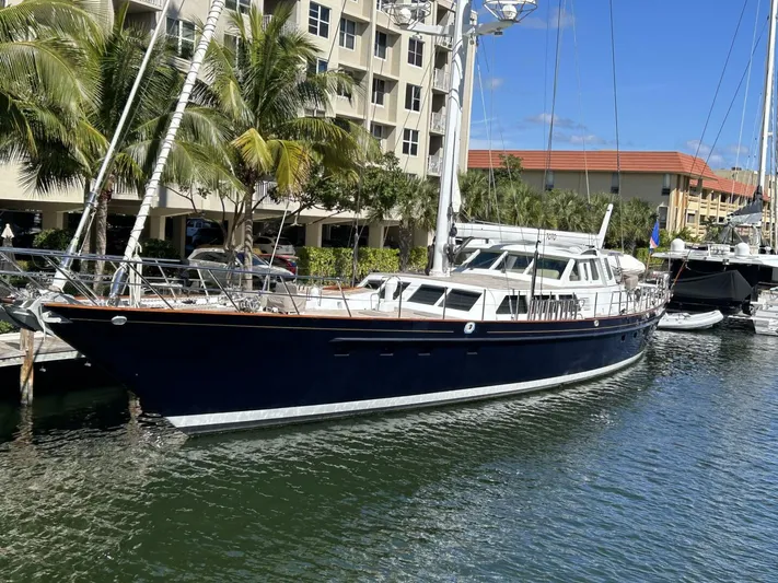 Toto Yacht Photos Pics 1983 Palmer Johnson 110 Cruising Sloop docked at marina with palm trees and buildings.