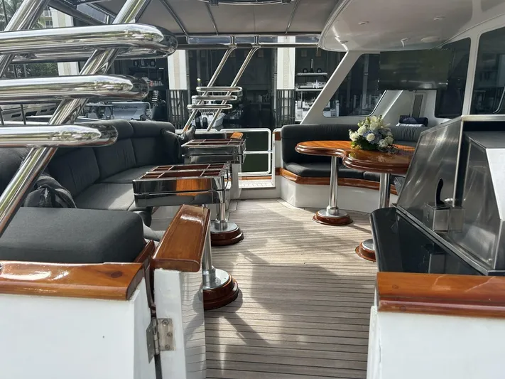 Toto Yacht Photos Pics Luxurious deck of 1983 Palmer Johnson 110 Cruising Sloop with seating and dining area.