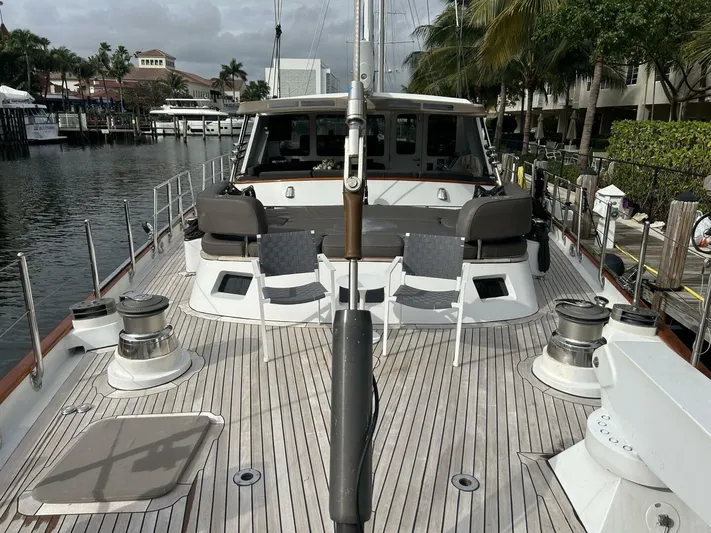 Toto Yacht Photos Pics Palmer Johnson 110 Cruising Sloop 1983 docked, showcasing spacious deck and seating area.