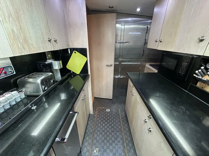 Toto Yacht Photos Pics 1983 Palmer Johnson 110 Cruising Sloop kitchen with black countertops and modern appliances.