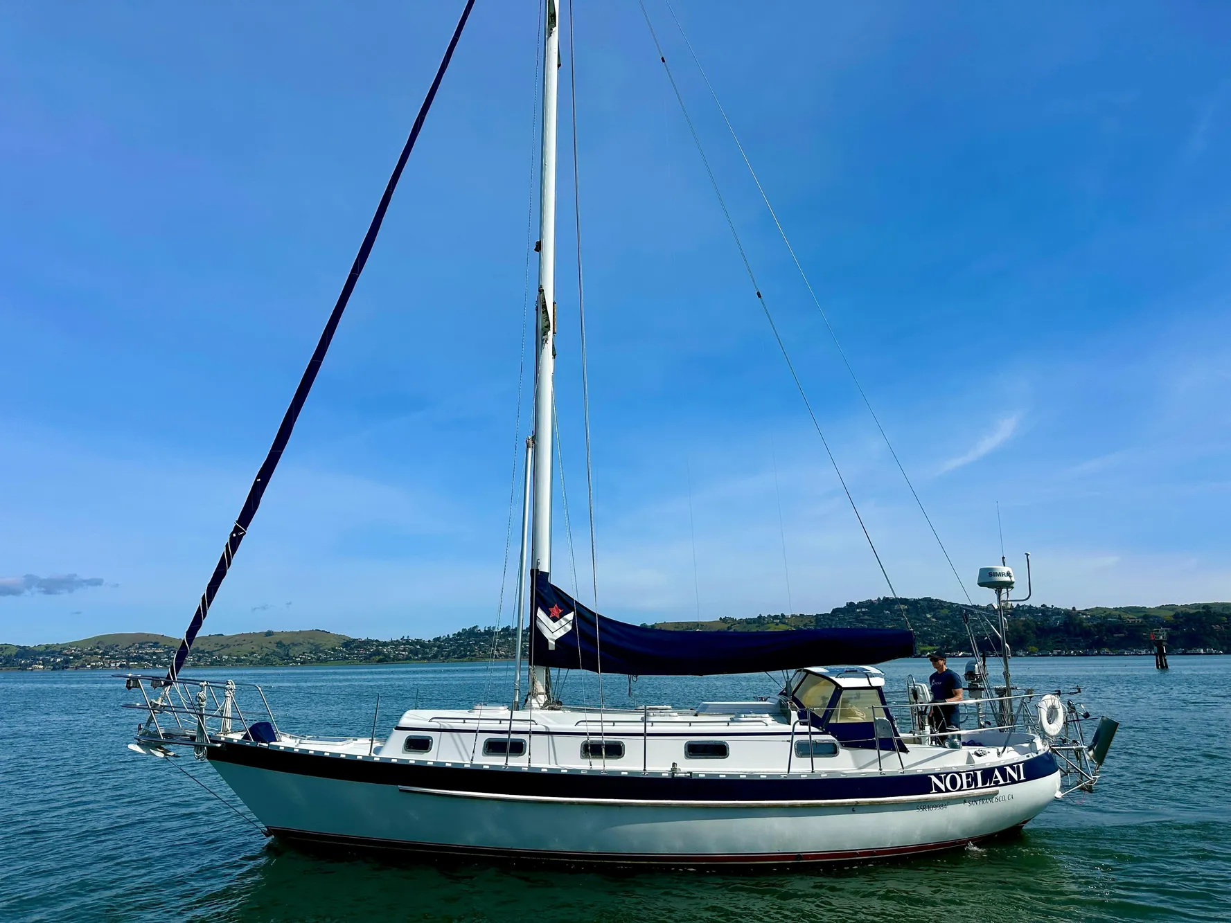 Sailboat Valiant 39, 1996 model, anchored on calm water under clear blue sky.