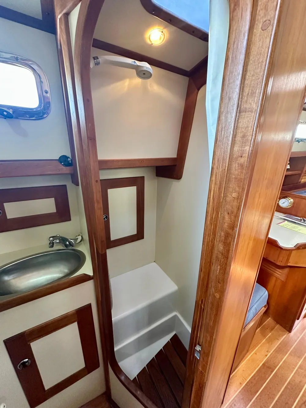 1996 Valiant 39 yacht bathroom with wooden trim and compact shower.