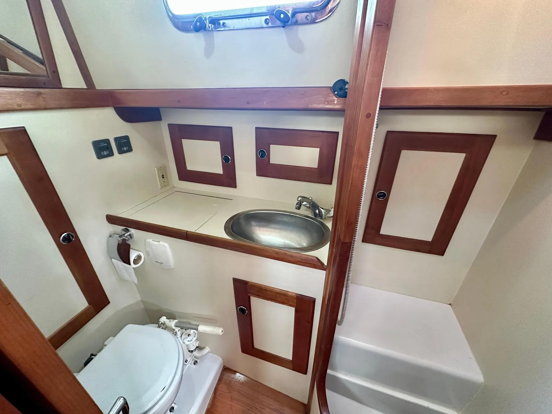 1996 Valiant 39 yacht bathroom with sink, toilet, and wooden accents.