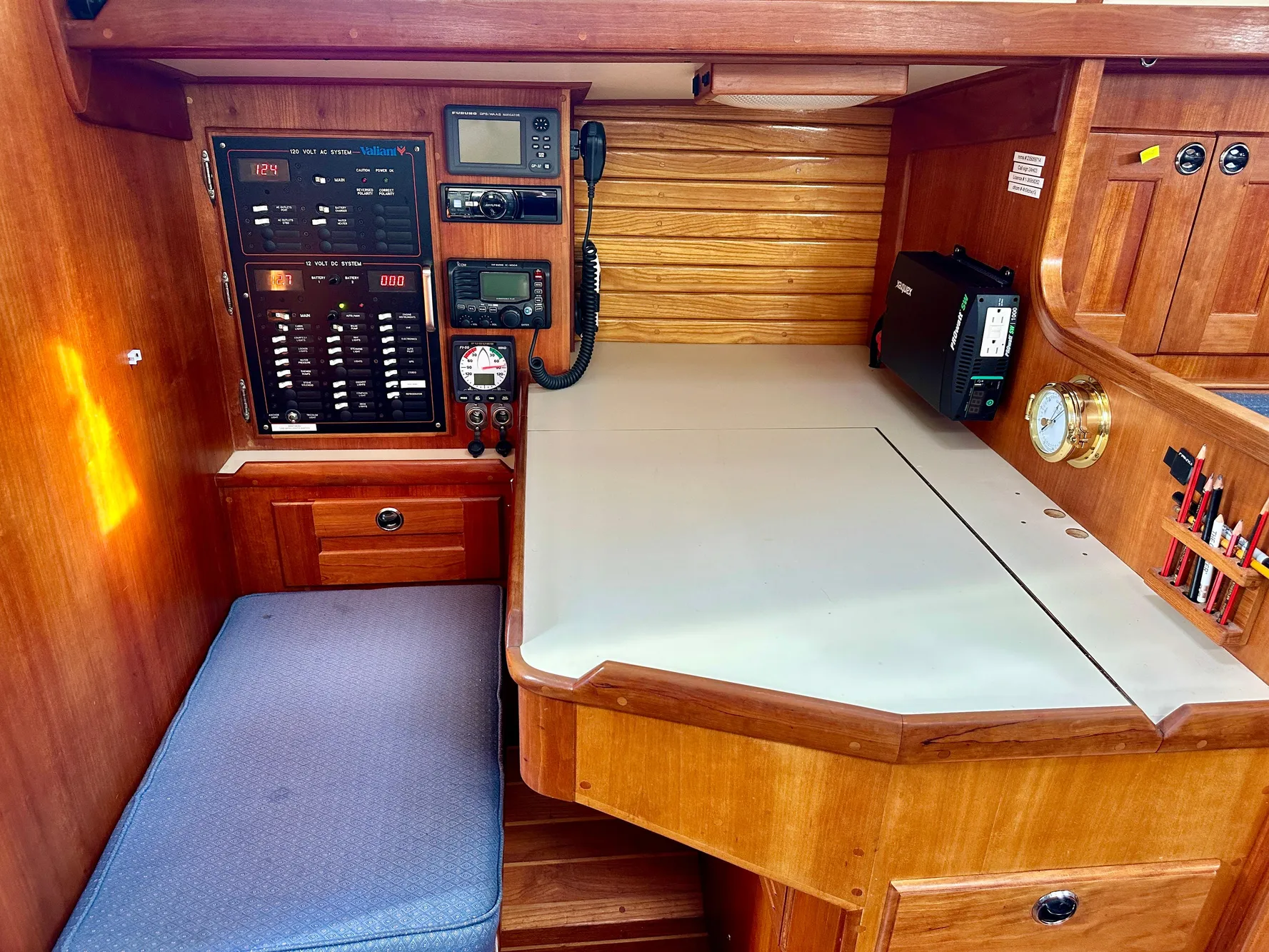 Navigation station in a 1996 Valiant 39 sailboat with control panel and seating.