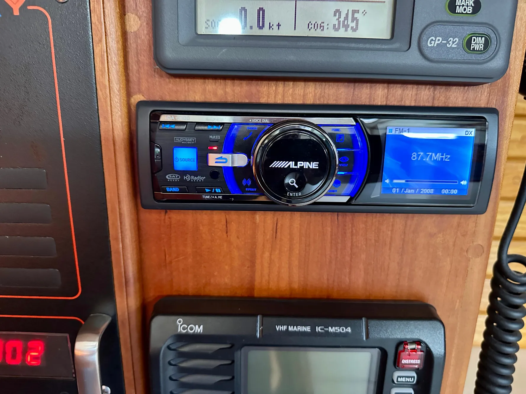 Alpine stereo system on a 1996 Valiant 39 boat dashboard with Icom VHF radio.