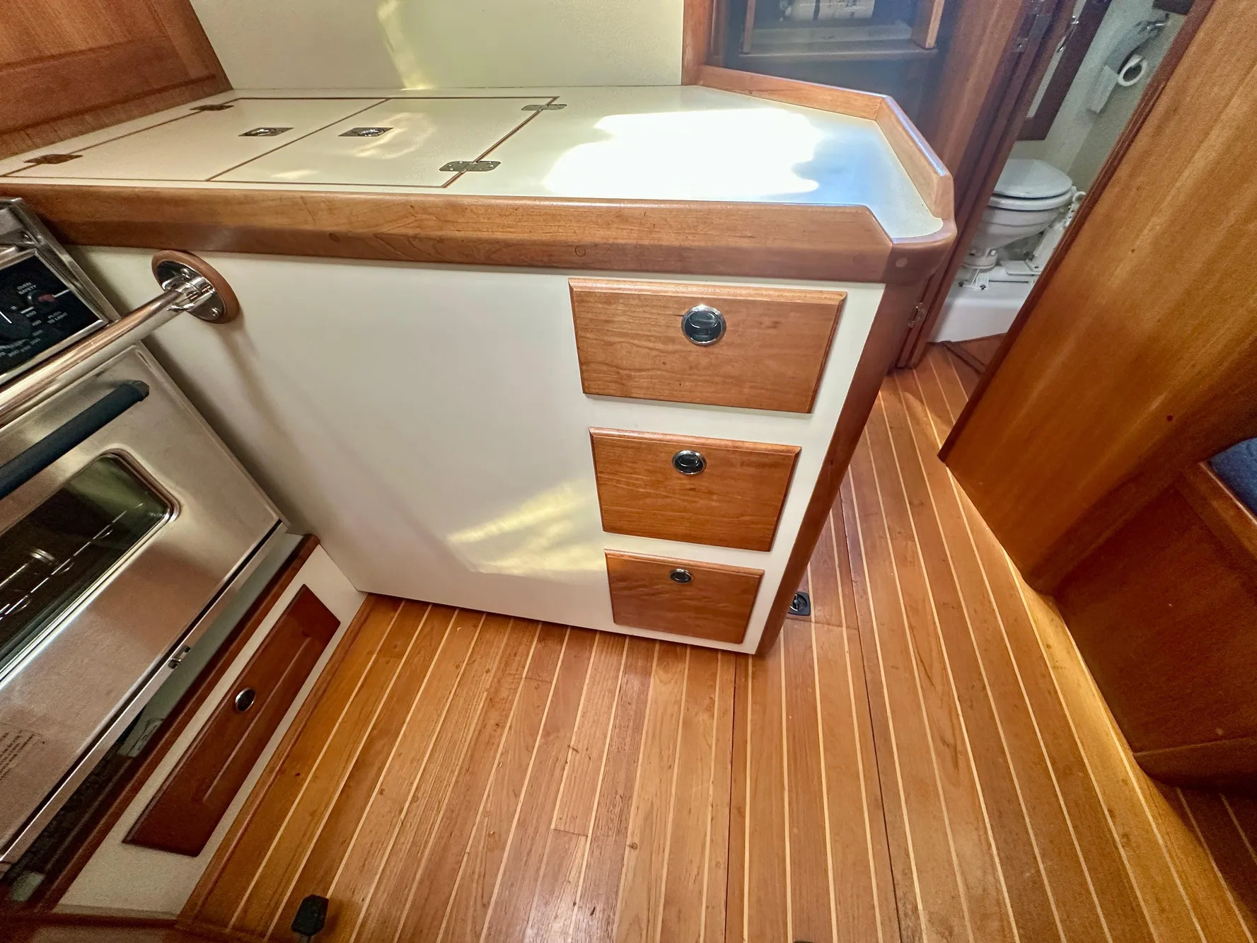 1996 Valiant 39 yacht interior with wooden cabinetry and flooring.