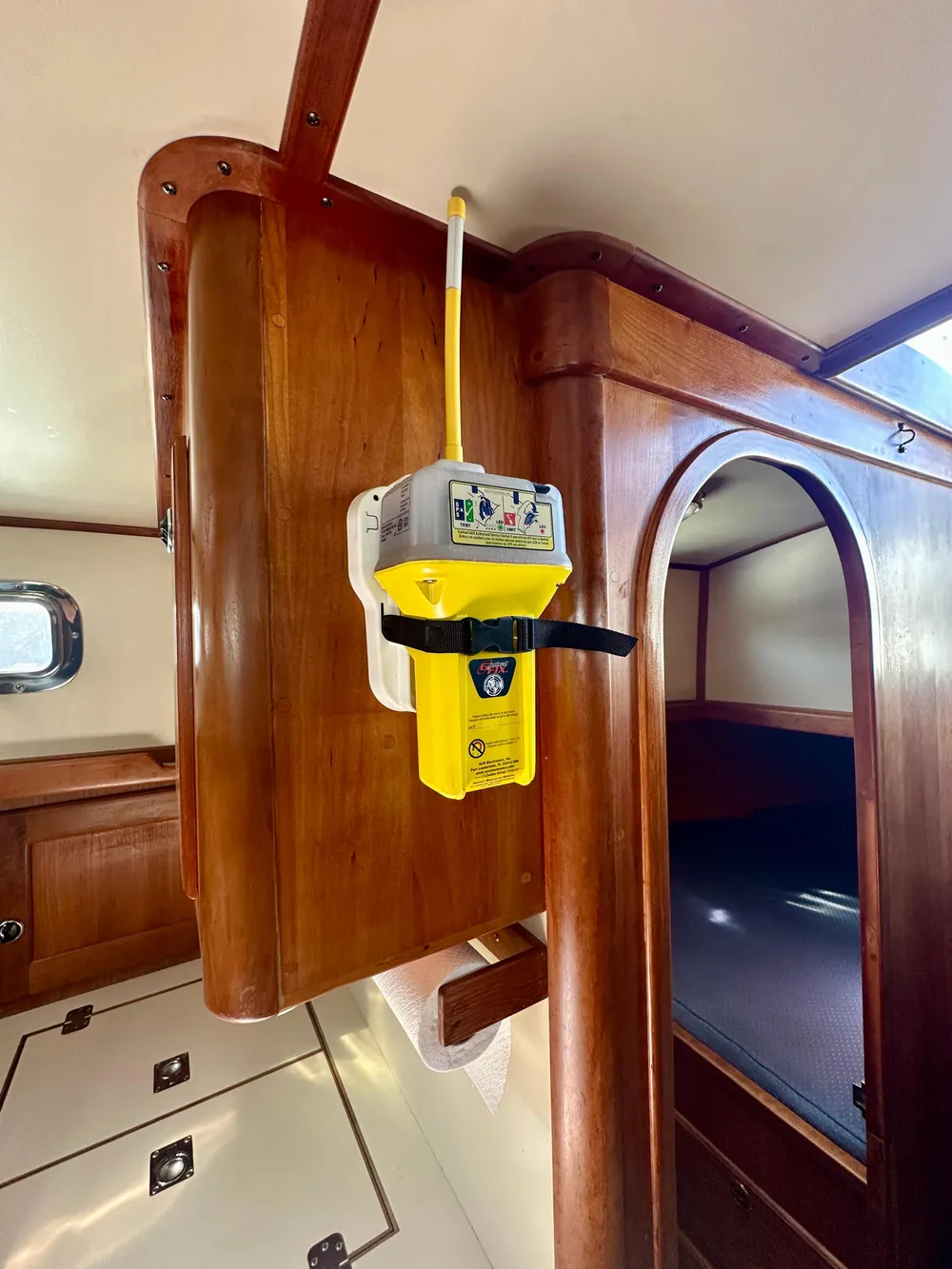 1996 Valiant 39 interior with mounted emergency beacon, wooden cabinetry, and cozy sleeping area.