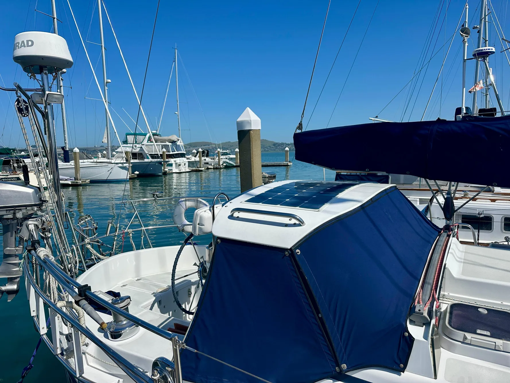 Valiant 39 sailboat, 1996 model, docked at marina with blue canopy and clear sky.