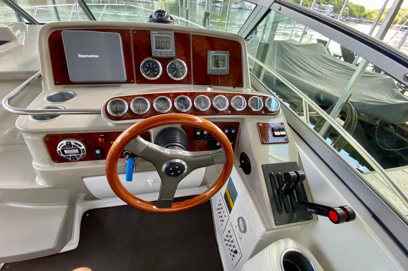  Yacht Photos Pics 2004 Formula 37 PC boat helm with wood steering wheel and control panel.