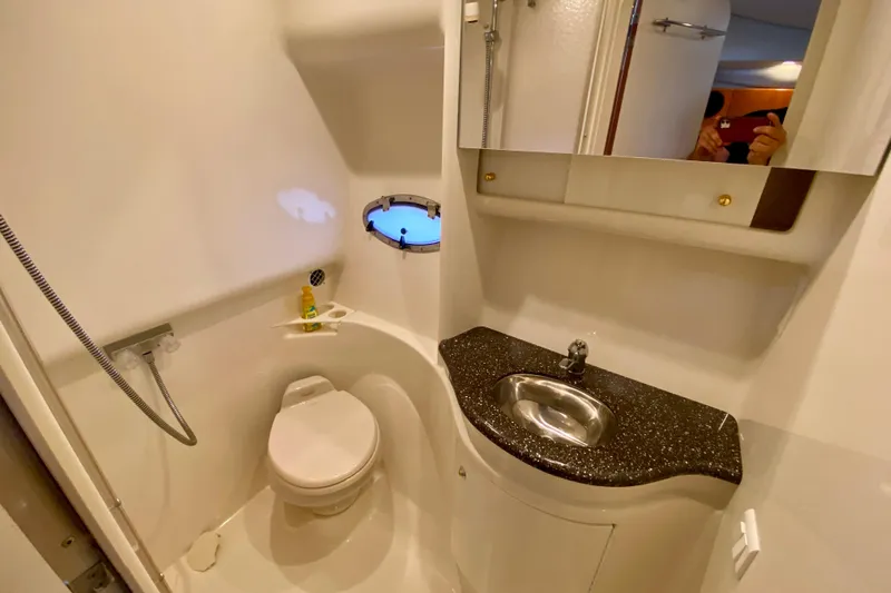 Yacht Photos Pics 2004 Formula 37 PC yacht bathroom with toilet, sink, and porthole window.