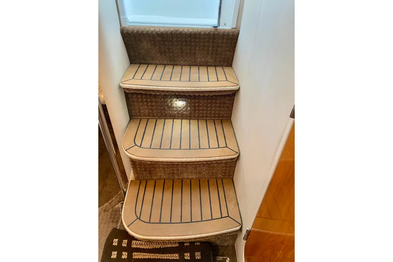  Yacht Photos Pics Interior stairs of a 2004 Formula 37 PC yacht with carpeted steps.