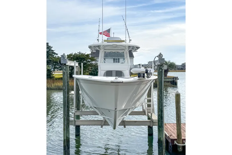  Yacht Photos Pics 2021 Cape Horn 31 T boat on lift, docked by waterfront with American flag.